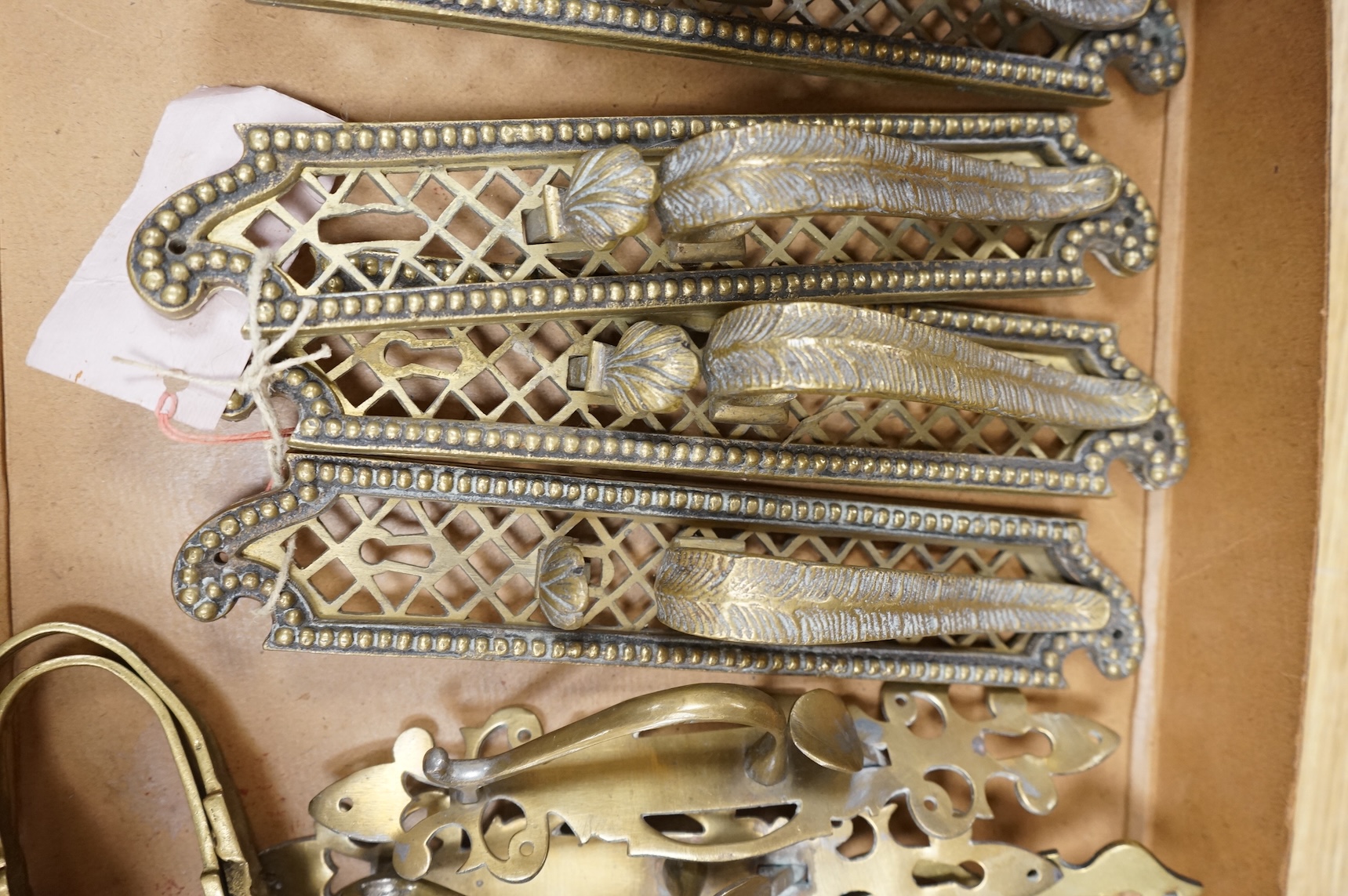 A collection of 19th century cast brass tie backs, largest 26cm high